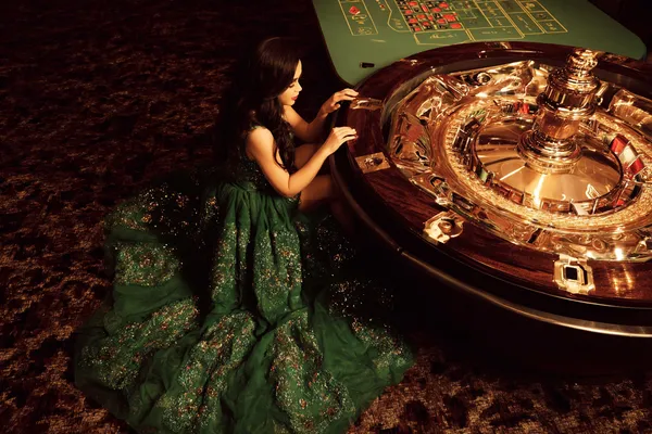 A glamorous woman holding casino chips in a neon-lit environment, representing the premium online casino atmosphere of JLMMM.