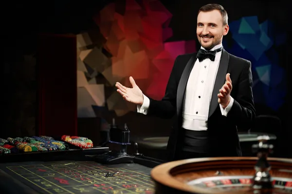 A glowing roulette wheel with cascading chips, symbolizing the engaging live and instant-win games available on JLMMM.